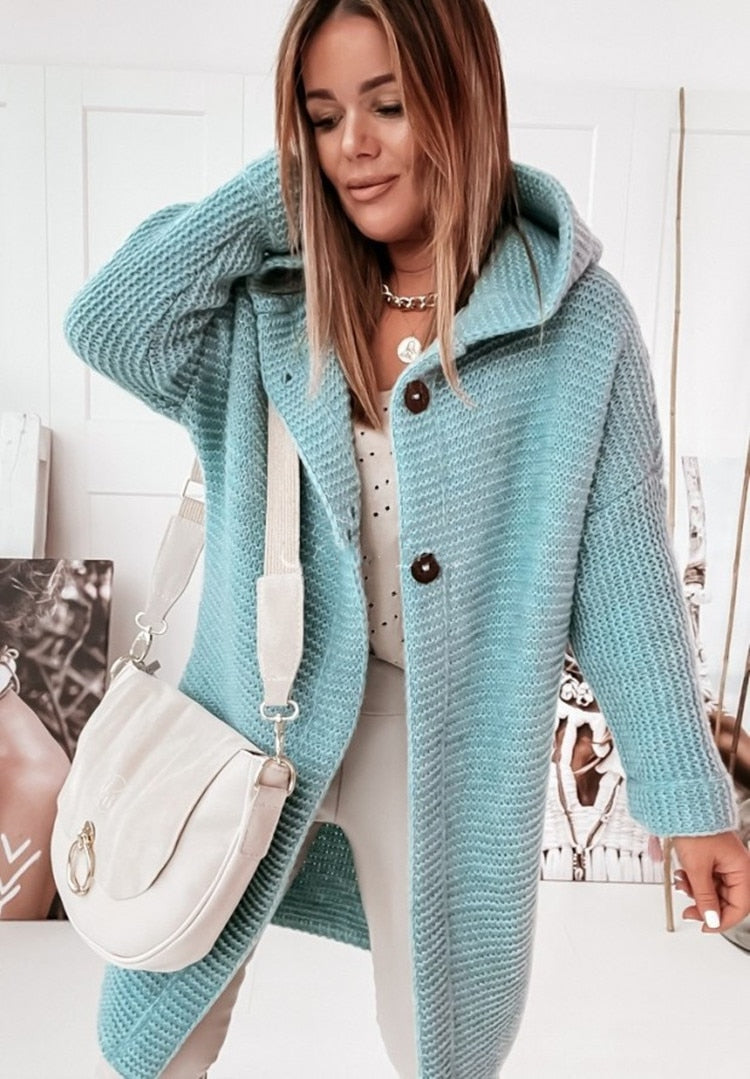 Women's hooded oversized chunky knit cardigan with large buttons in a soft neutral shade