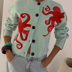 Light blue women's button-front cardigan with a bold octopus pattern across the front and sleeves