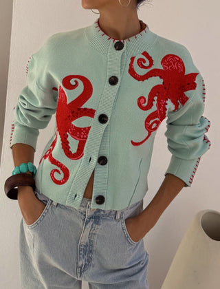 Light blue women's button-front cardigan with a bold octopus pattern across the front and sleeves
