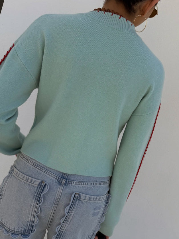 Light blue women's button-front cardigan with a bold octopus pattern across the front and sleeves