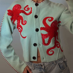 Light blue women's button-front cardigan with a bold octopus pattern across the front and sleeves
