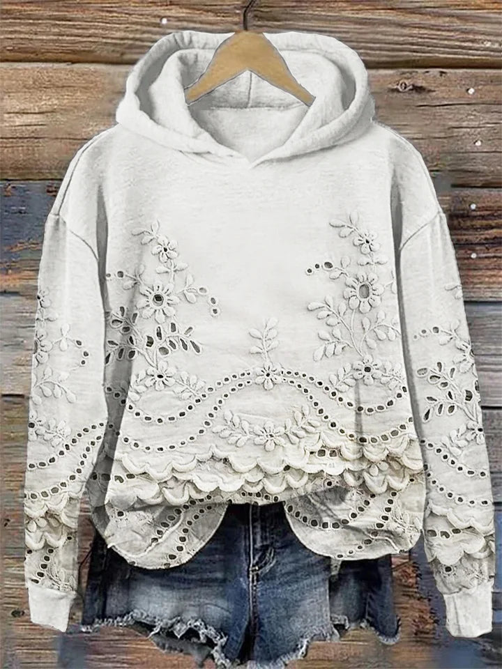 Women's floral eyelet pullover hoodie with structured hood and scalloped hem
