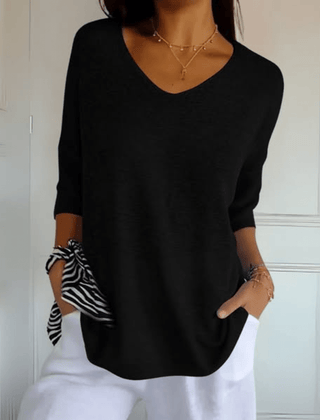 Women's V-neck sweater with a loose, relaxed silhouette shown in multiple colours