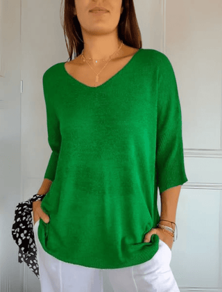 Women's V-neck sweater with a loose, relaxed silhouette shown in multiple colours