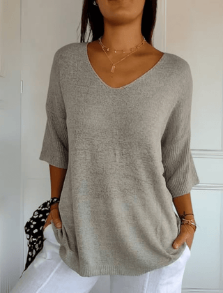 Women's V-neck sweater with a loose, relaxed silhouette shown in multiple colours