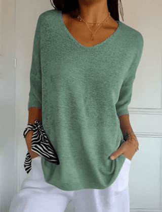 Women's V-neck sweater with a loose, relaxed silhouette shown in multiple colours
