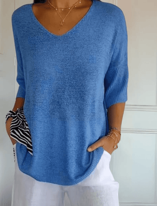 Women's V-neck sweater with a loose, relaxed silhouette shown in multiple colours
