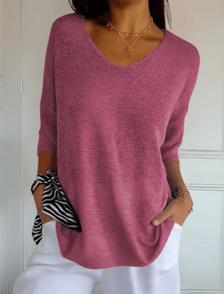 Women's V-neck sweater with a loose, relaxed silhouette shown in multiple colours