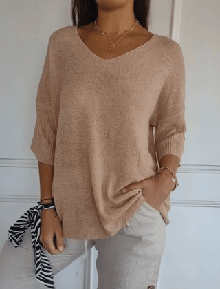 Women's V-neck sweater with a loose, relaxed silhouette shown in multiple colours