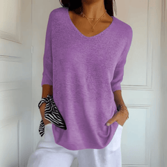Women's V-neck sweater with a loose, relaxed silhouette shown in multiple colours