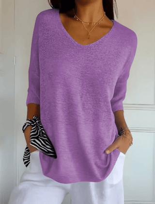 Women's V-neck sweater with a loose, relaxed silhouette shown in multiple colours