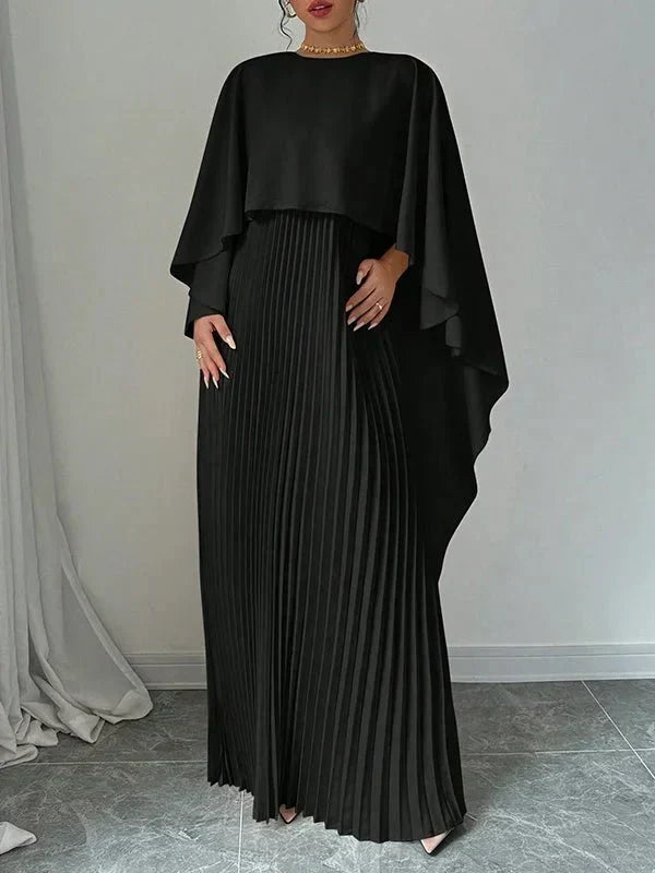 Elegant pleated cape maxi dress with flowing overlay and floor-length skirt