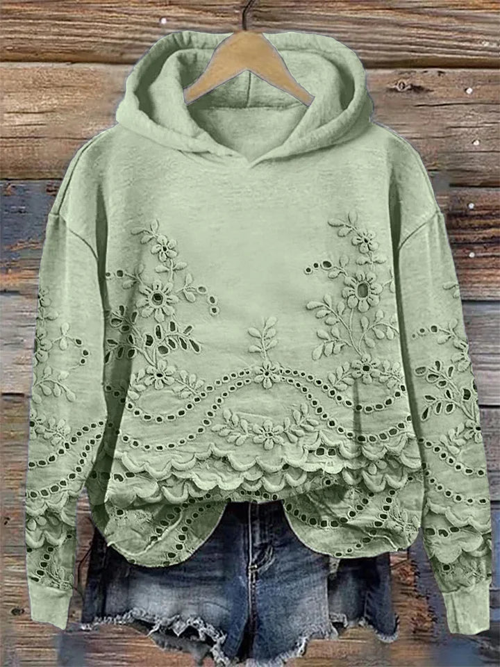 Women's floral eyelet pullover hoodie with structured hood and scalloped hem