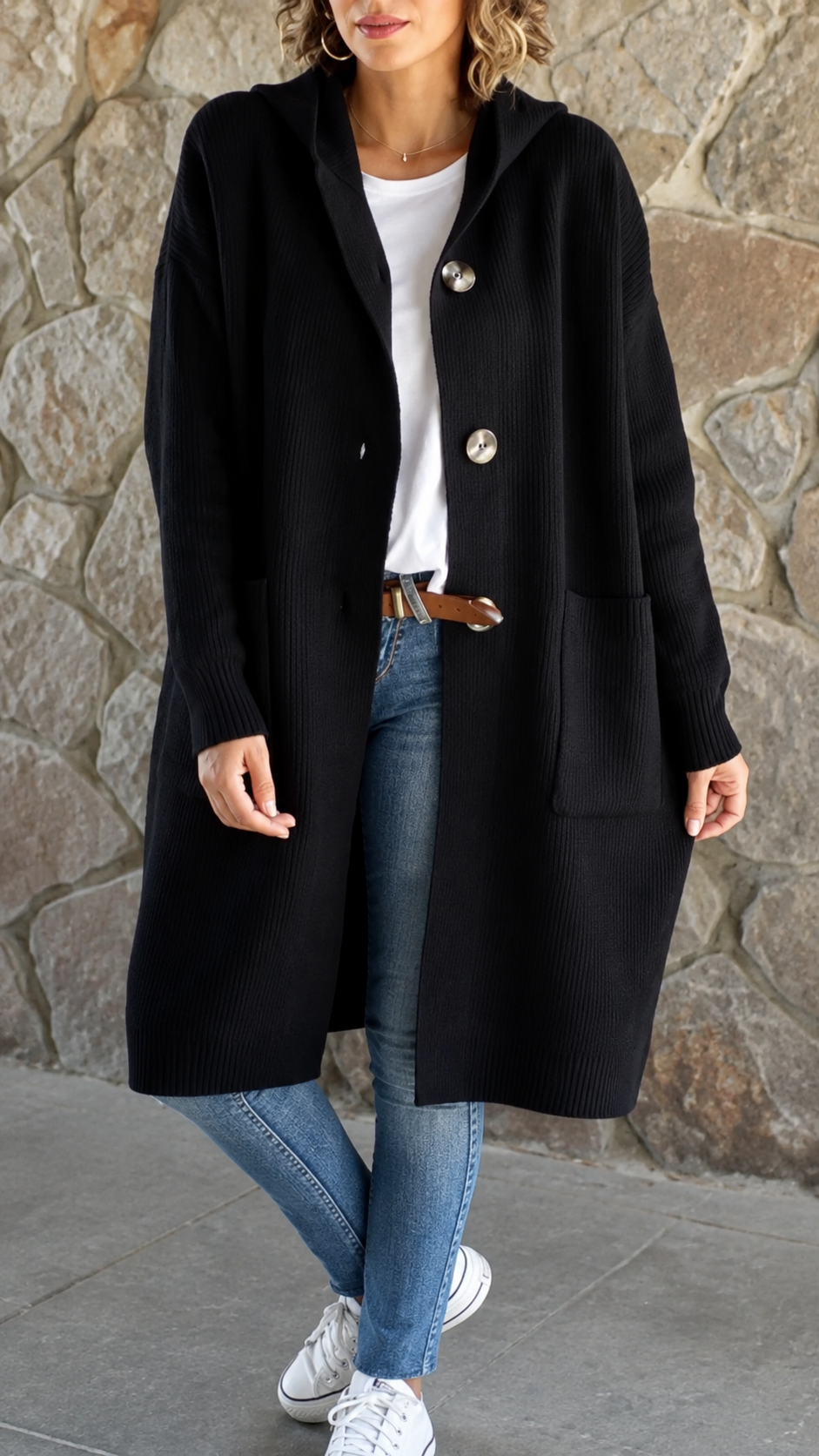 Woman wearing a long flowing knit cardigan in a neutral shade over a casual outfit