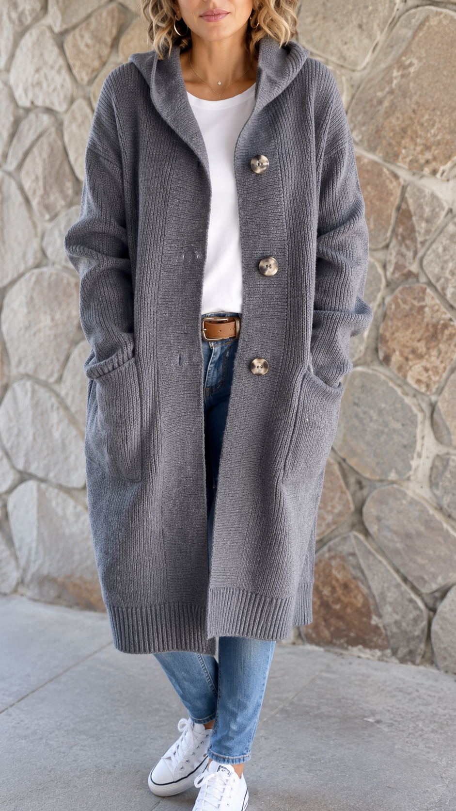 Woman wearing a long flowing knit cardigan in a neutral shade over a casual outfit