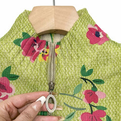 Lime green zip-up bomber cardigan with pink and coral floral print and metal zipper pull