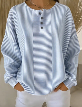 Woman wearing a casual striped loose waffle-knit sweatshirt with a relaxed fit