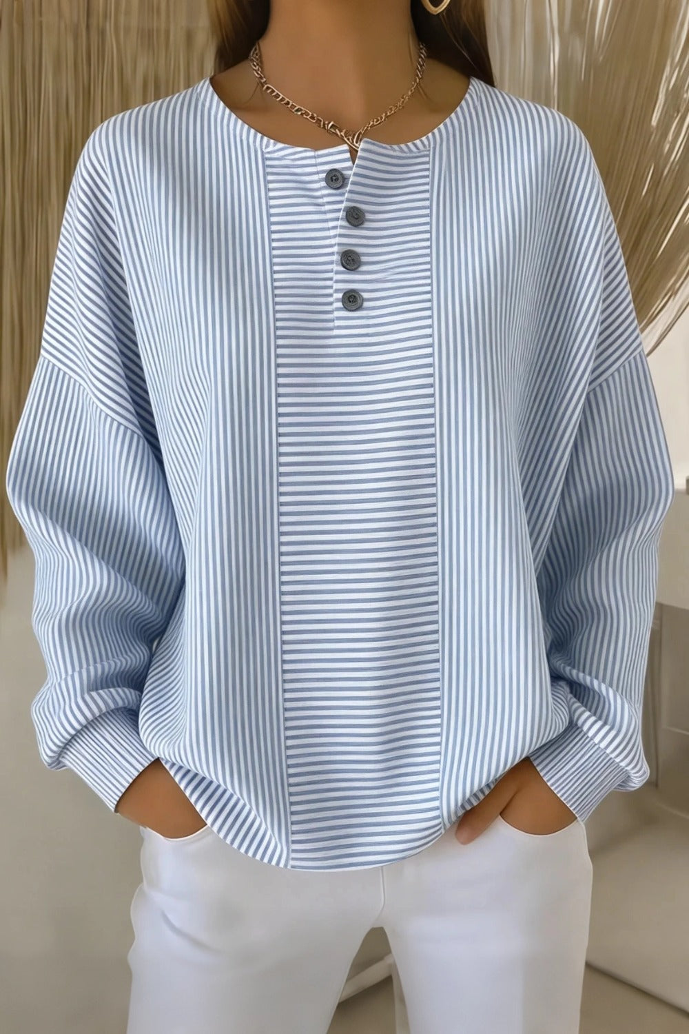 Woman wearing a casual striped loose waffle-knit sweatshirt with a relaxed fit