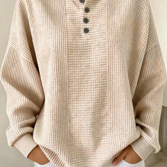 Woman wearing a casual striped waffle-knit sweatshirt with a relaxed fit