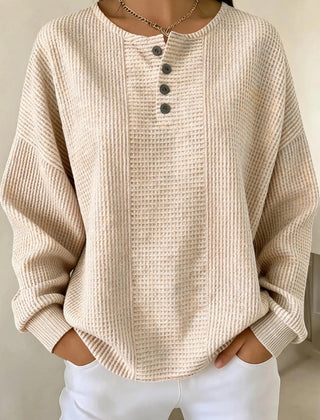 Woman wearing a casual striped waffle-knit sweatshirt with a relaxed fit