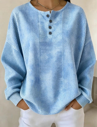 Woman wearing a casual striped waffle-knit sweatshirt with a relaxed fit