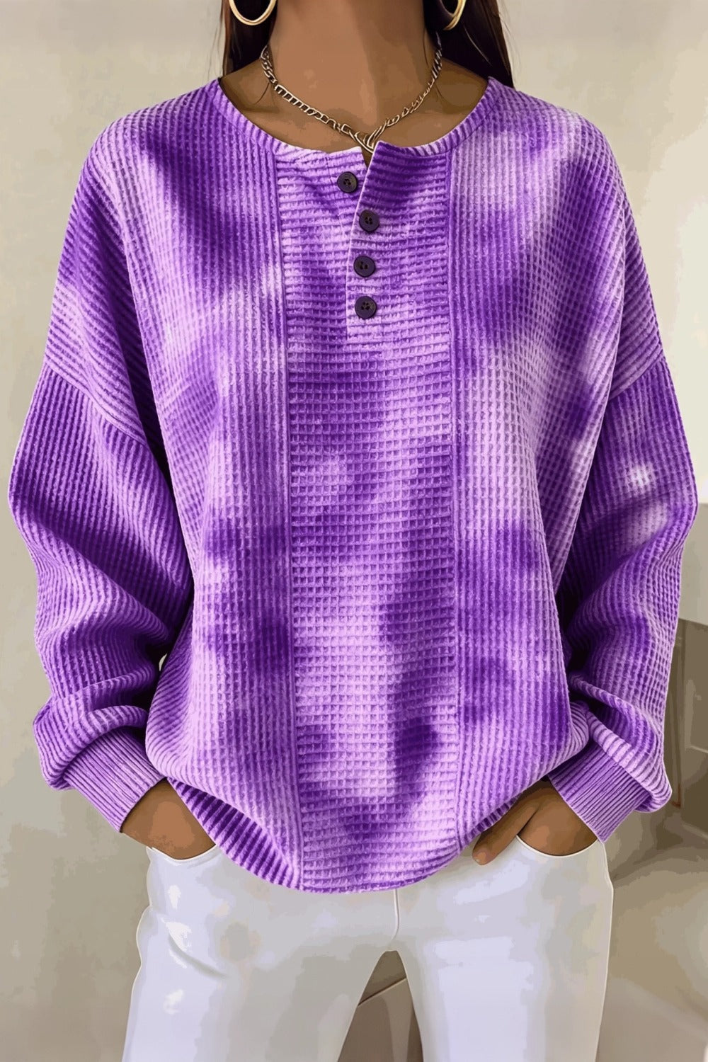Woman wearing a casual striped waffle-knit sweatshirt with a relaxed fit