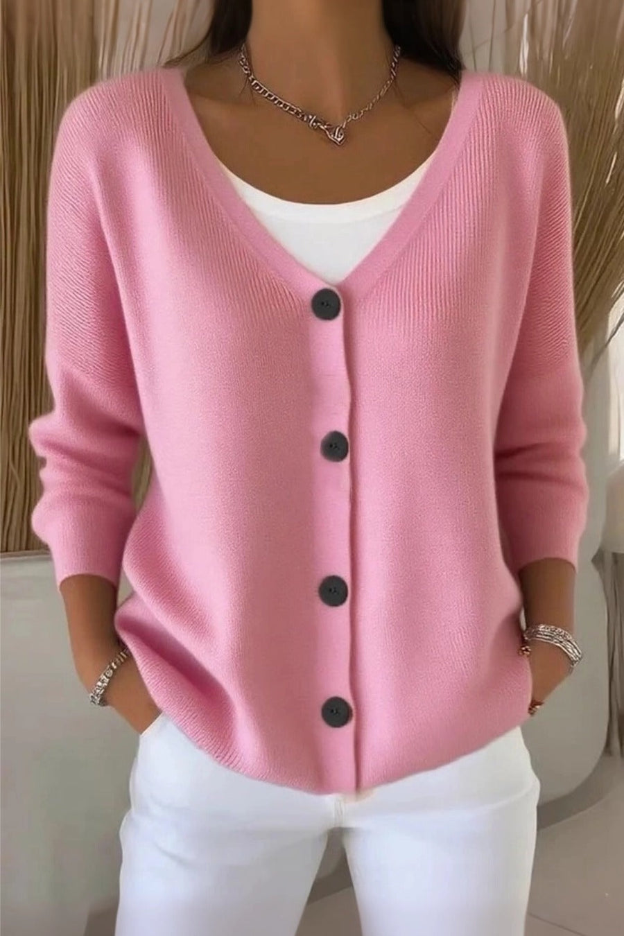 Woman wearing a plain long sleeve loose-fit V-neck casual cardigan