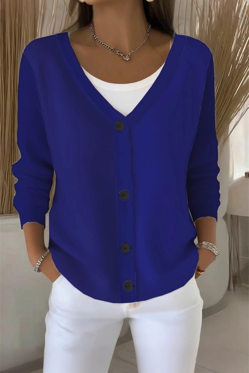 Woman wearing a plain long sleeve loose-fit V-neck casual cardigan