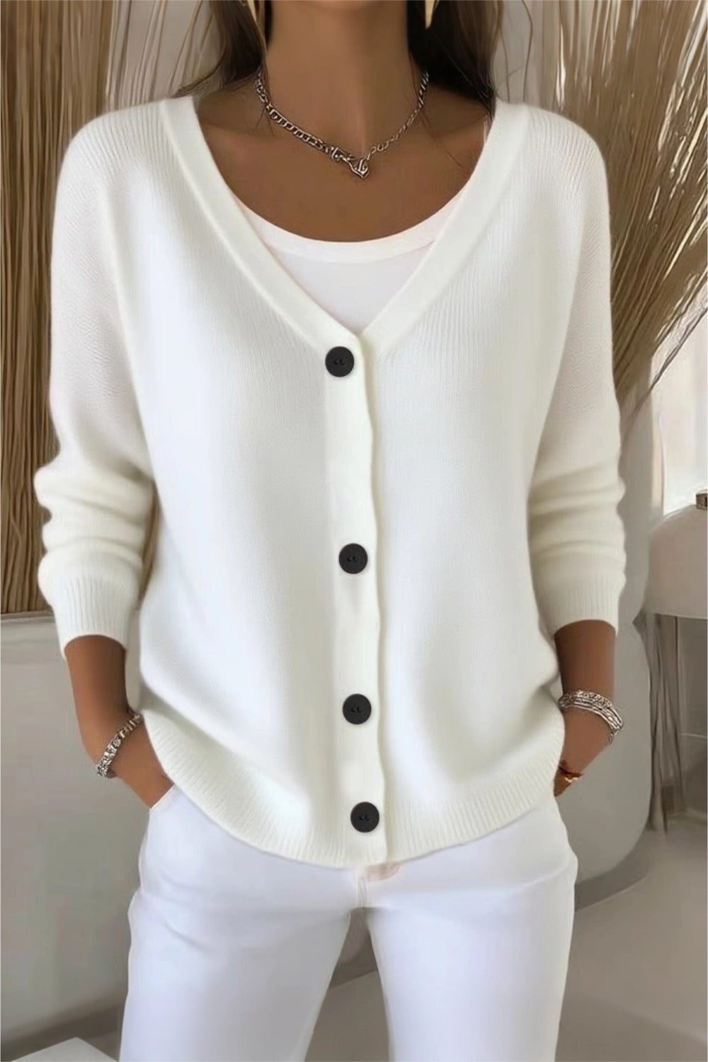 Woman wearing a plain long sleeve loose-fit V-neck casual cardigan