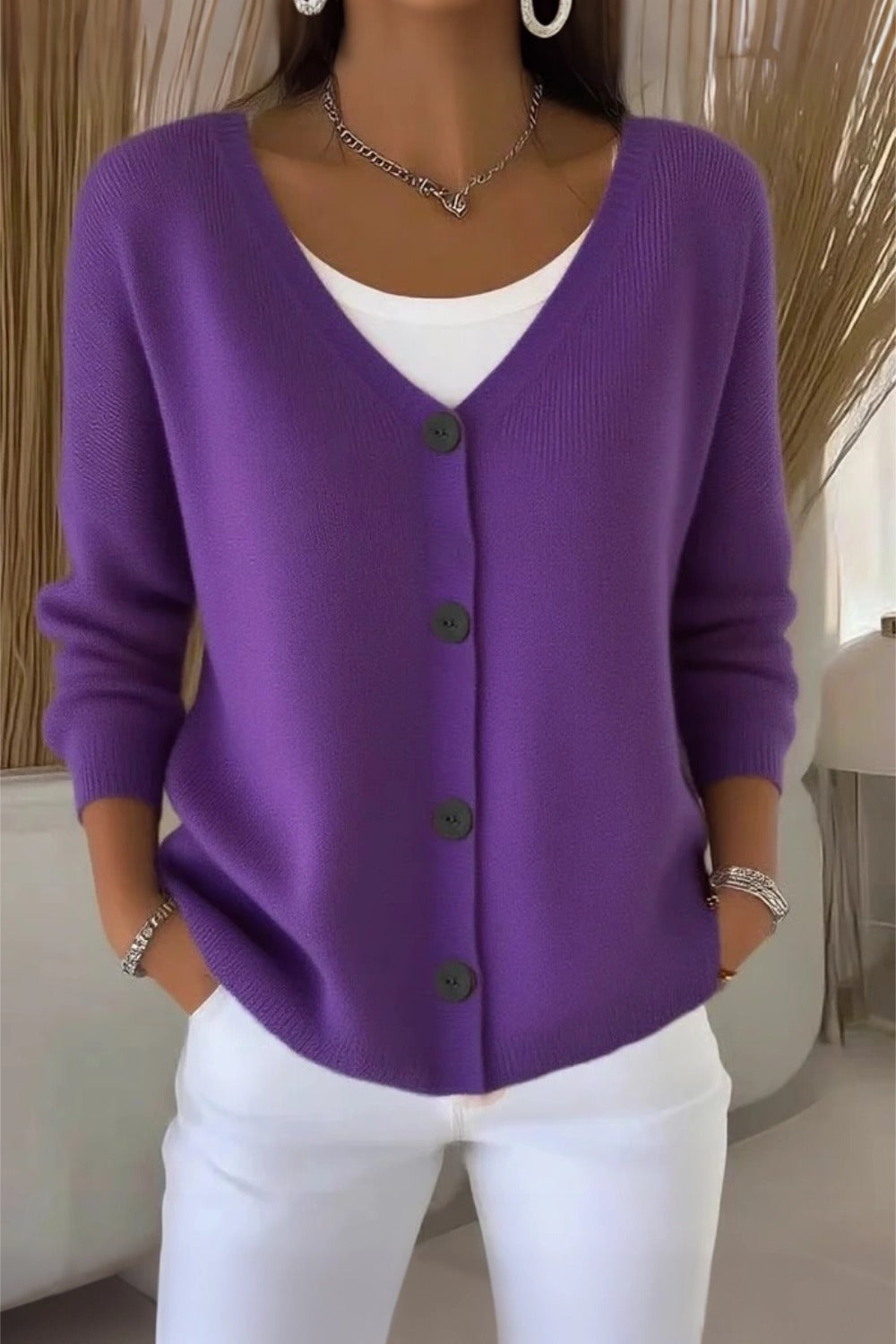 Woman wearing a plain long sleeve loose-fit V-neck casual cardigan