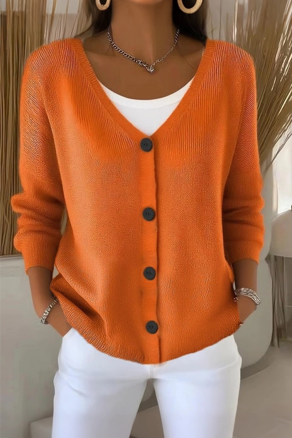Woman wearing a plain long sleeve loose-fit V-neck casual cardigan