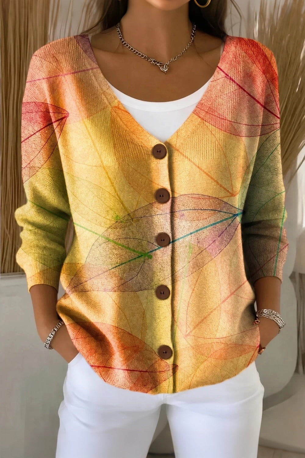 Woman wearing a yellow V-neck knit cardigan with subtle leaf texture and long sleeves