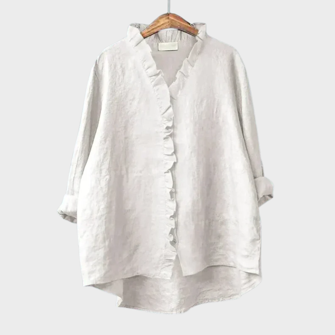 Woman wearing a feminine ruffle-trim blouse with a relaxed, gently draped fit