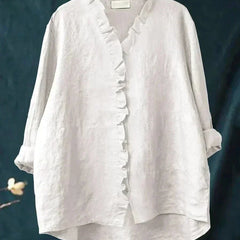 Woman wearing a feminine ruffle-trim blouse with a relaxed, gently draped fit