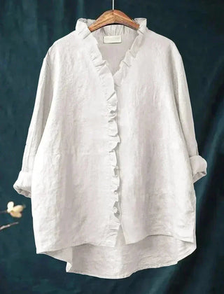 Woman wearing a feminine ruffle-trim blouse with a relaxed, gently draped fit