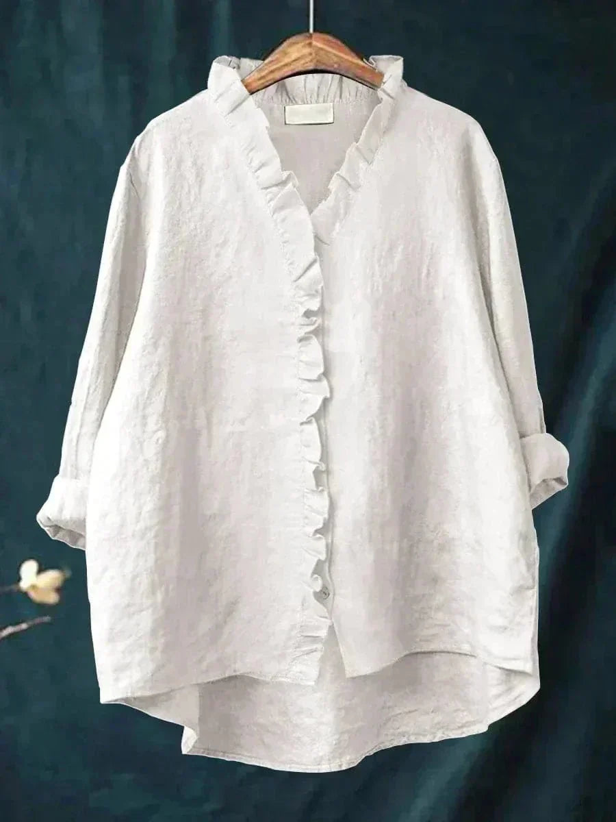 Woman wearing a feminine ruffle-trim blouse with a relaxed, gently draped fit