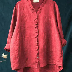 Woman wearing a feminine ruffle-trim blouse with a relaxed, gently draped fit