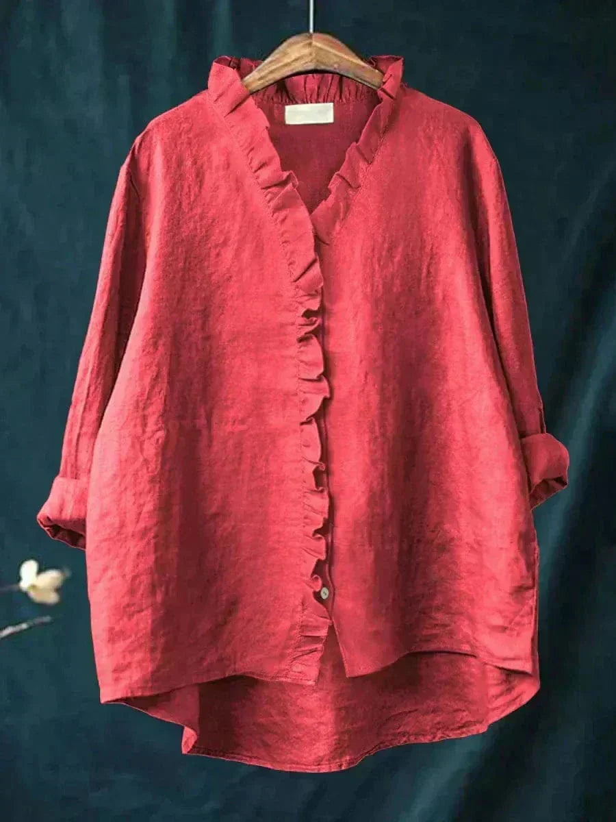 Woman wearing a feminine ruffle-trim blouse with a relaxed, gently draped fit