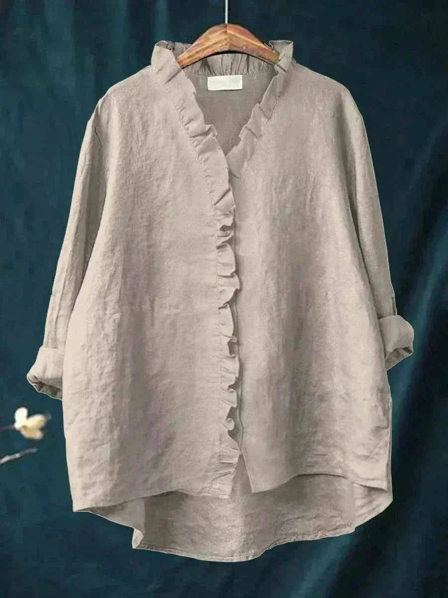 Woman wearing a feminine ruffle-trim blouse with a relaxed, gently draped fit