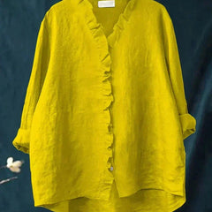 Woman wearing a feminine ruffle-trim blouse with a relaxed, gently draped fit