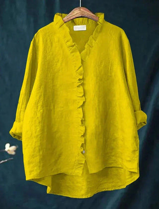 Woman wearing a feminine ruffle-trim blouse with a relaxed, gently draped fit