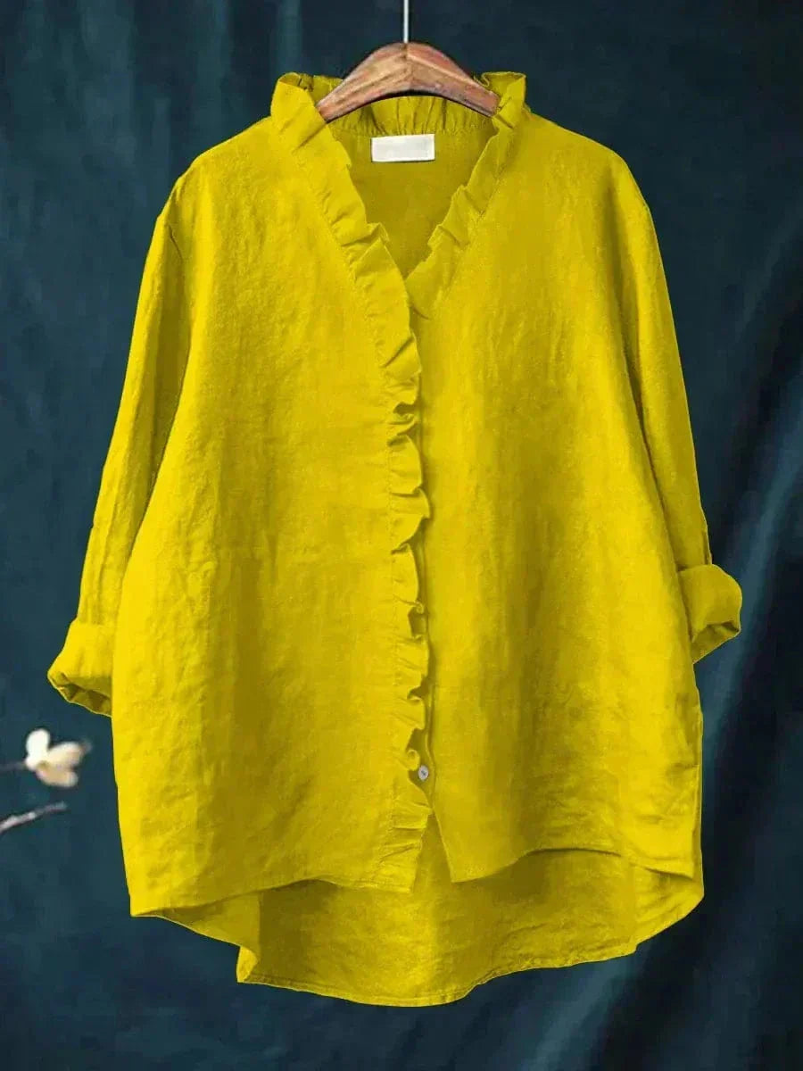 Woman wearing a feminine ruffle-trim blouse with a relaxed, gently draped fit
