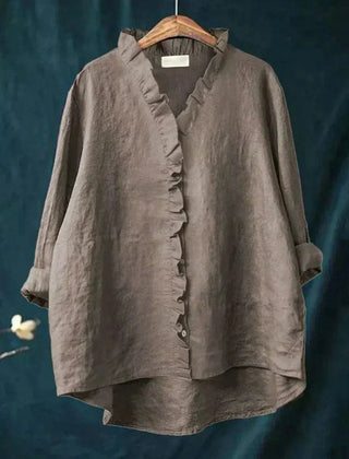 Woman wearing a feminine ruffle-trim blouse with a relaxed, gently draped fit