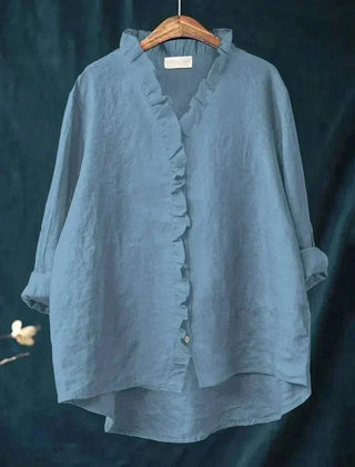 Woman wearing a feminine ruffle-trim blouse with a relaxed, gently draped fit