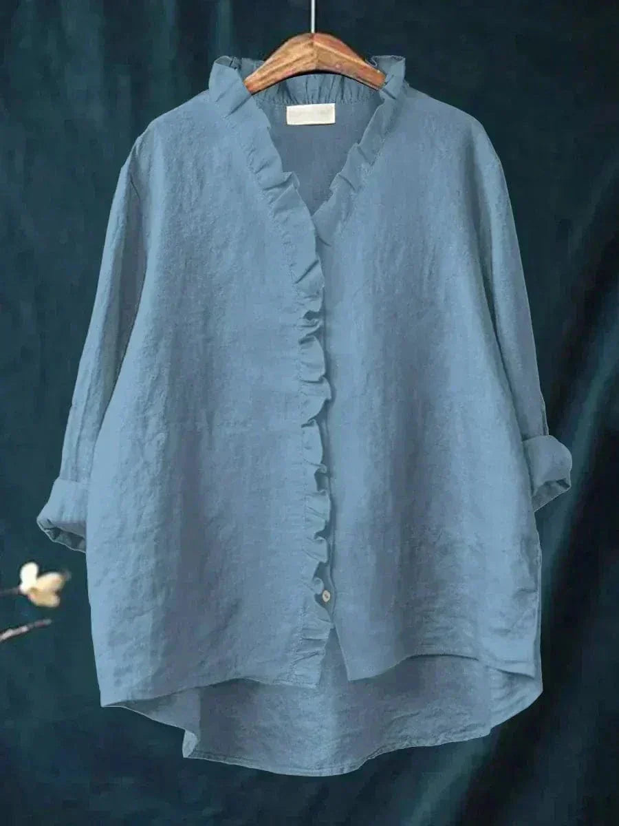 Woman wearing a feminine ruffle-trim blouse with a relaxed, gently draped fit