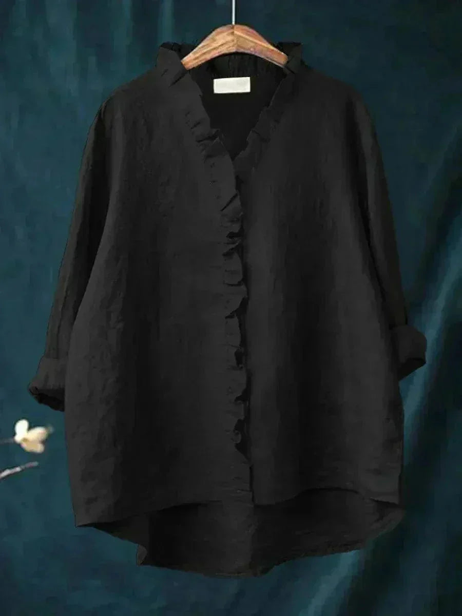 Woman wearing a feminine ruffle-trim blouse with a relaxed, gently draped fit