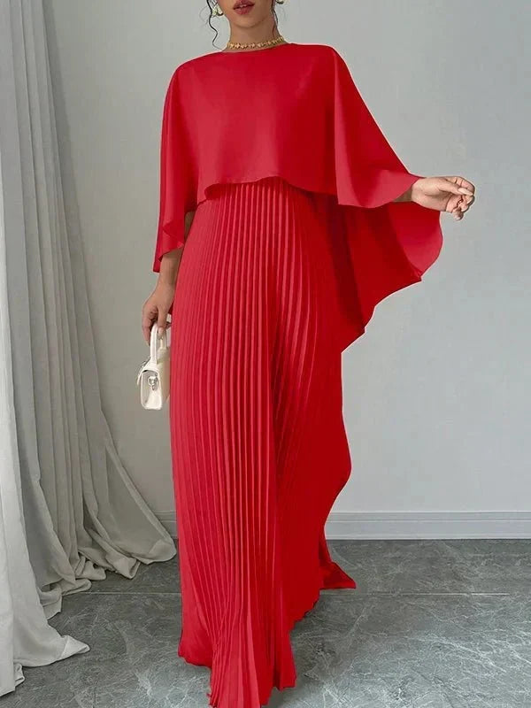 Elegant pleated cape maxi dress with flowing overlay and floor-length skirt