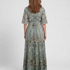 Green V-neck maxi dress with flowing floor-length skirt