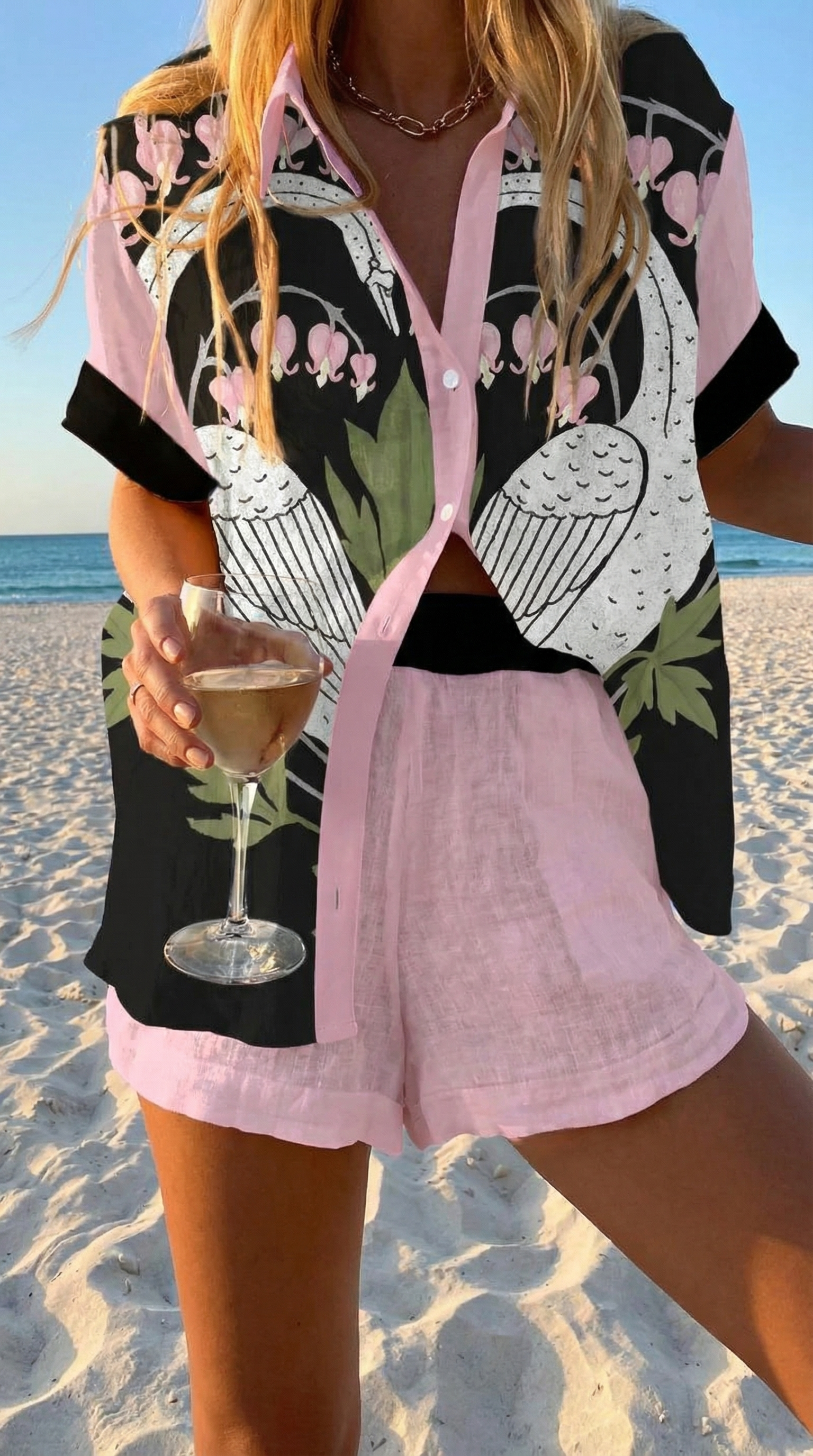 Women's coordinated set with black swan and floral print shirt and pale pink shorts