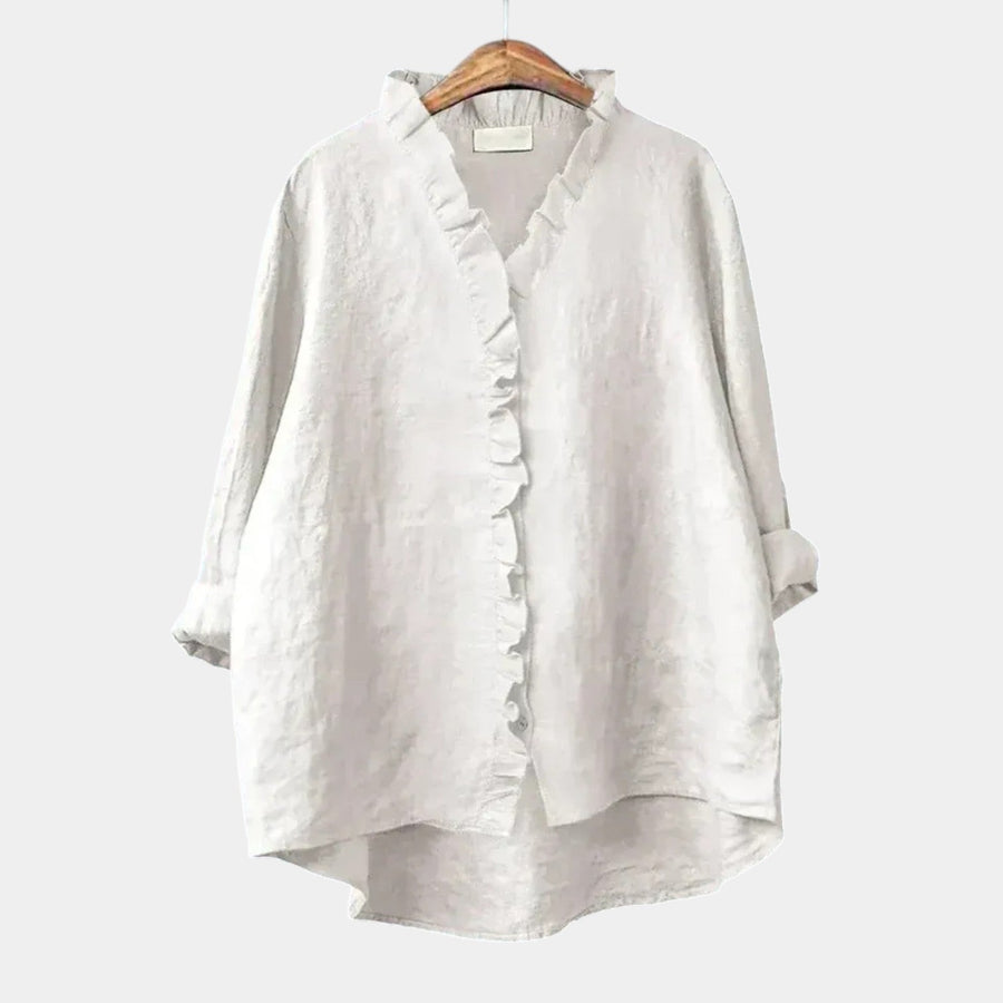 Woman wearing an elegant printed long-sleeve summer blouse in a relaxed fit